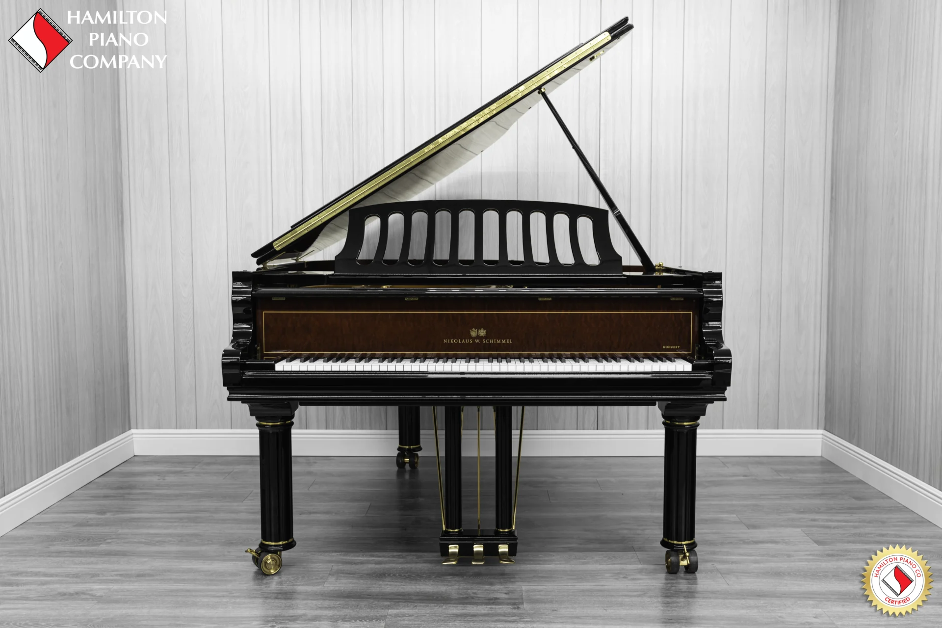 a beautiful Schimmel Meisterstücke NWS Edition Grand Piano, finished in polished ebony with mahogany accents and brass hardware.
