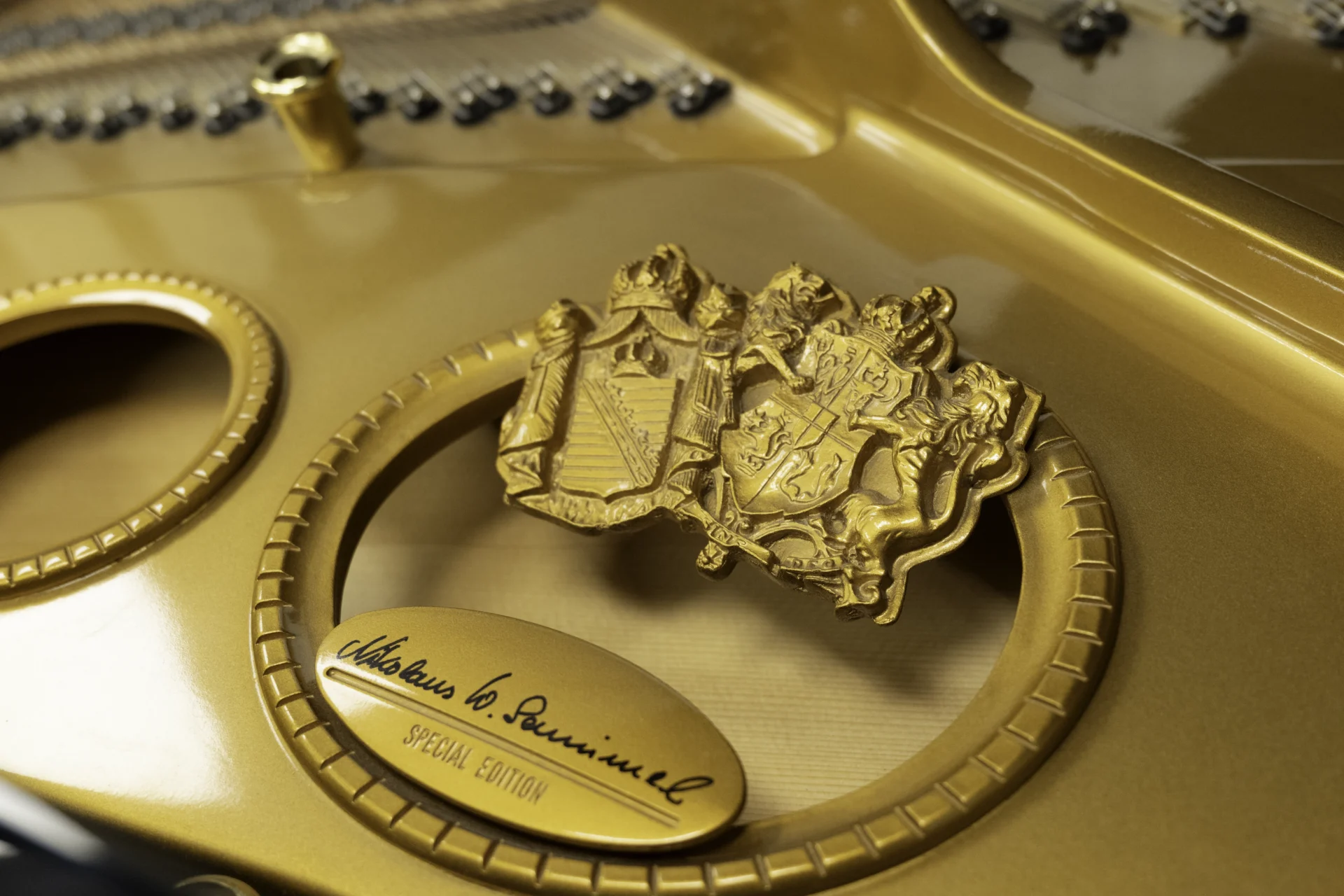 a close up of the signature of Nikolaus Wilhelm Schimmel as it appears on the harp of this Schimmel Meisterstücke NWS Edition Grand Piano.