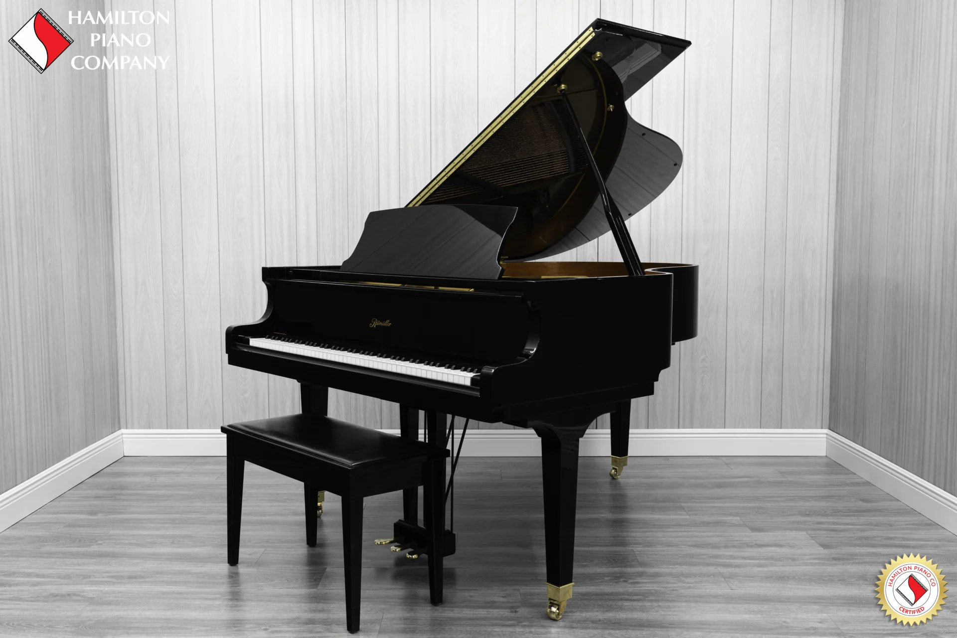 Ritmuller grand piano in high polish ebony finish with bench.