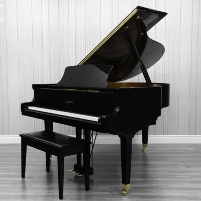 Ritmuller grand piano in high polish ebony finish with bench.