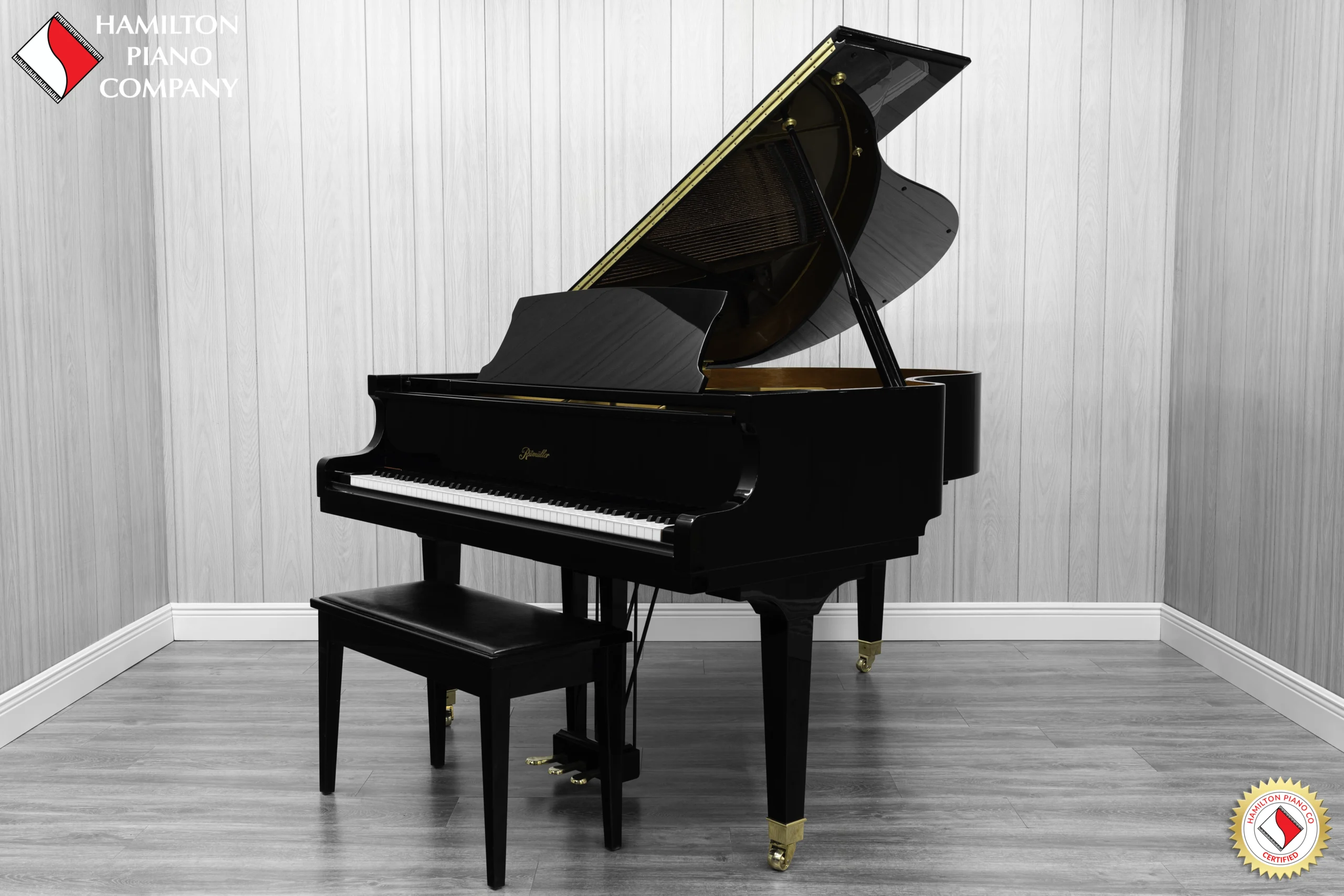 Ritmuller grand piano in high polish ebony finish with bench.