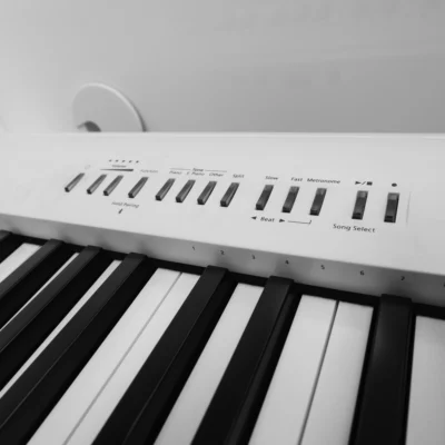 Roland FP-30X digital piano in a white and transparent acrylic shell with full-size weighted keys and modern design