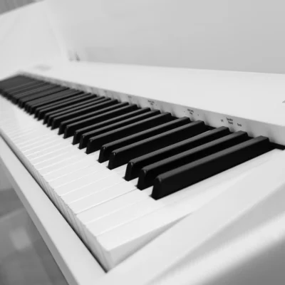 Roland FP-30X digital piano in a white and transparent acrylic shell with full-size weighted keys and modern design
