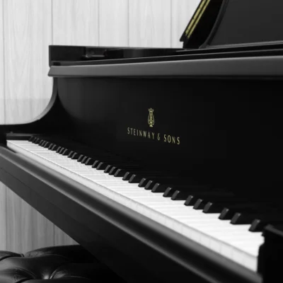 1984 Steinway B Grand Piano in satin ebony finish. This image shows off the keys and steinway logo on the fallboard