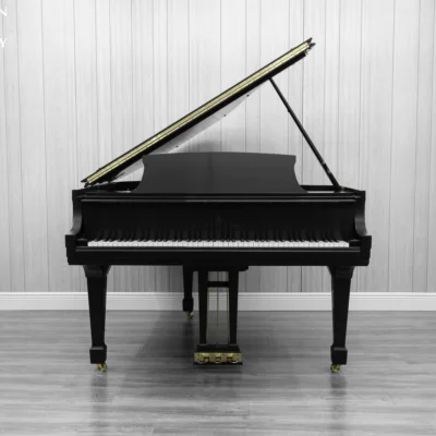 A Steinway M baby grand piano in a beautiful satin ebony finish with brass hardware.