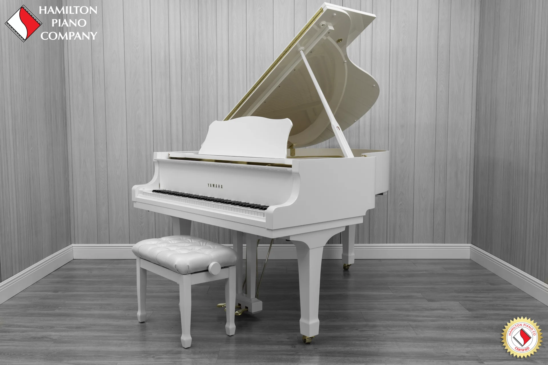 A 1980 Yamaha G3 Grand Piano in a high polish white finish with bench.
