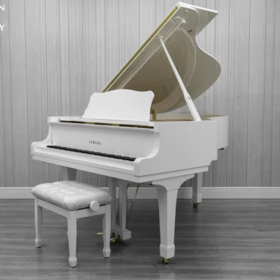 A 1980 Yamaha G3 Grand Piano in a high polish white finish with bench.