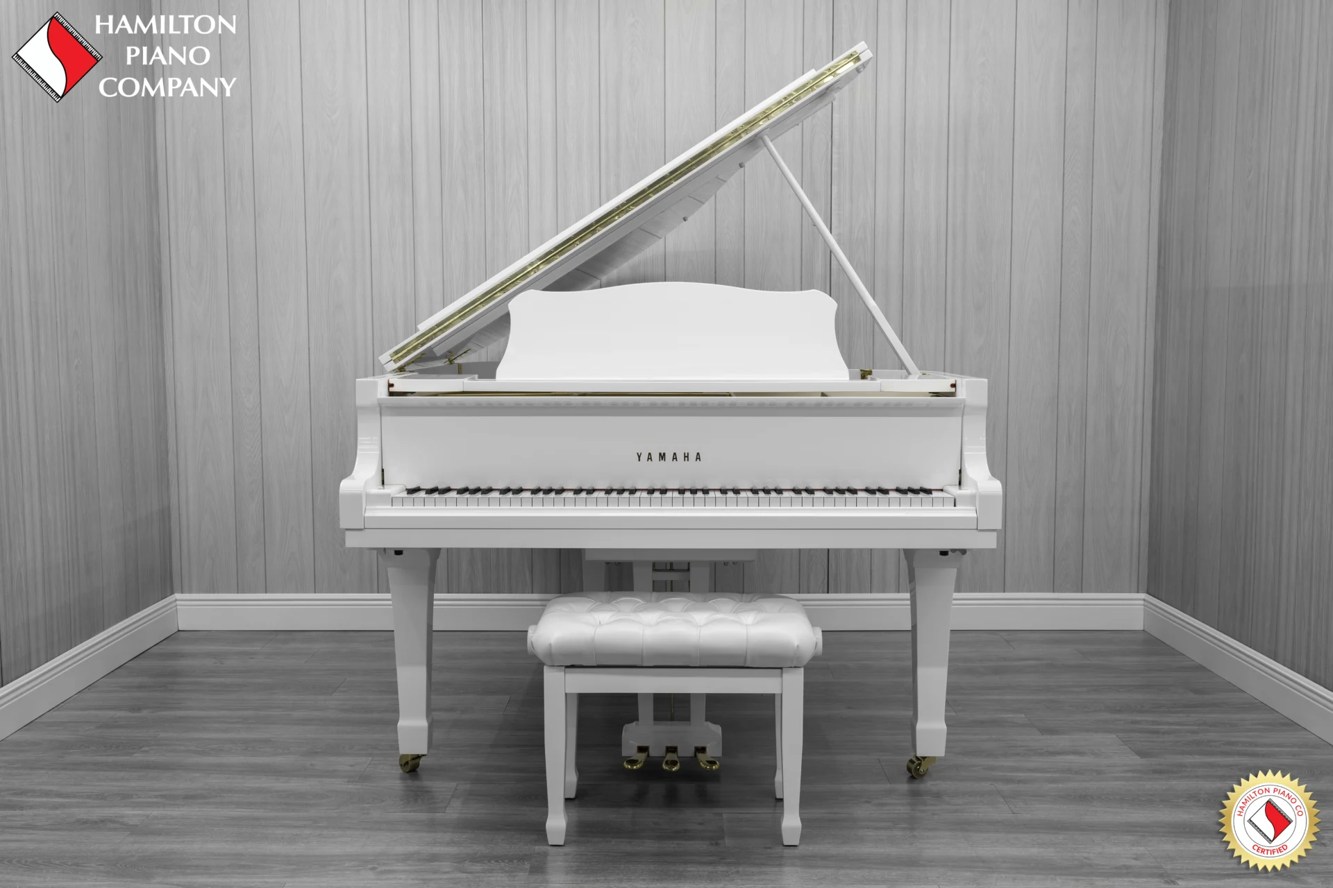A 1980 Yamaha G3 Grand Piano in a high polish white finish with bench.