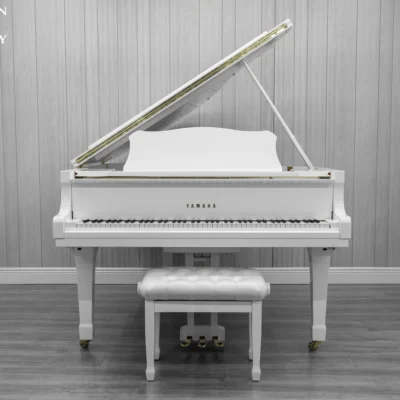A 1980 Yamaha G3 Grand Piano in a high polish white finish with bench.