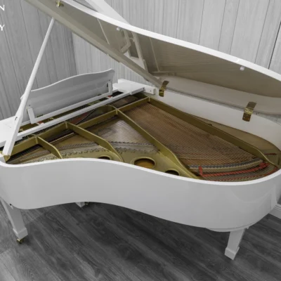 A 1980 Yamaha G3 Grand Piano in a high polish white finish. The image shows of the interior of the piano, including the harp and strings.