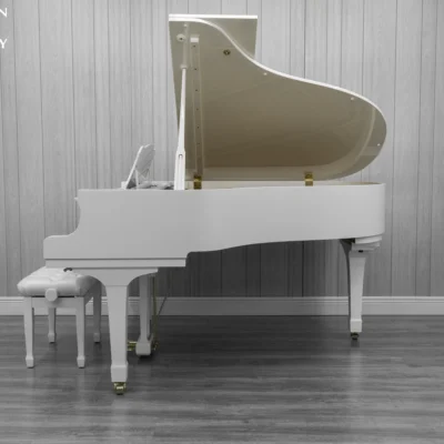 A 1980 Yamaha G3 Grand Piano in a high polish white finish with bench.