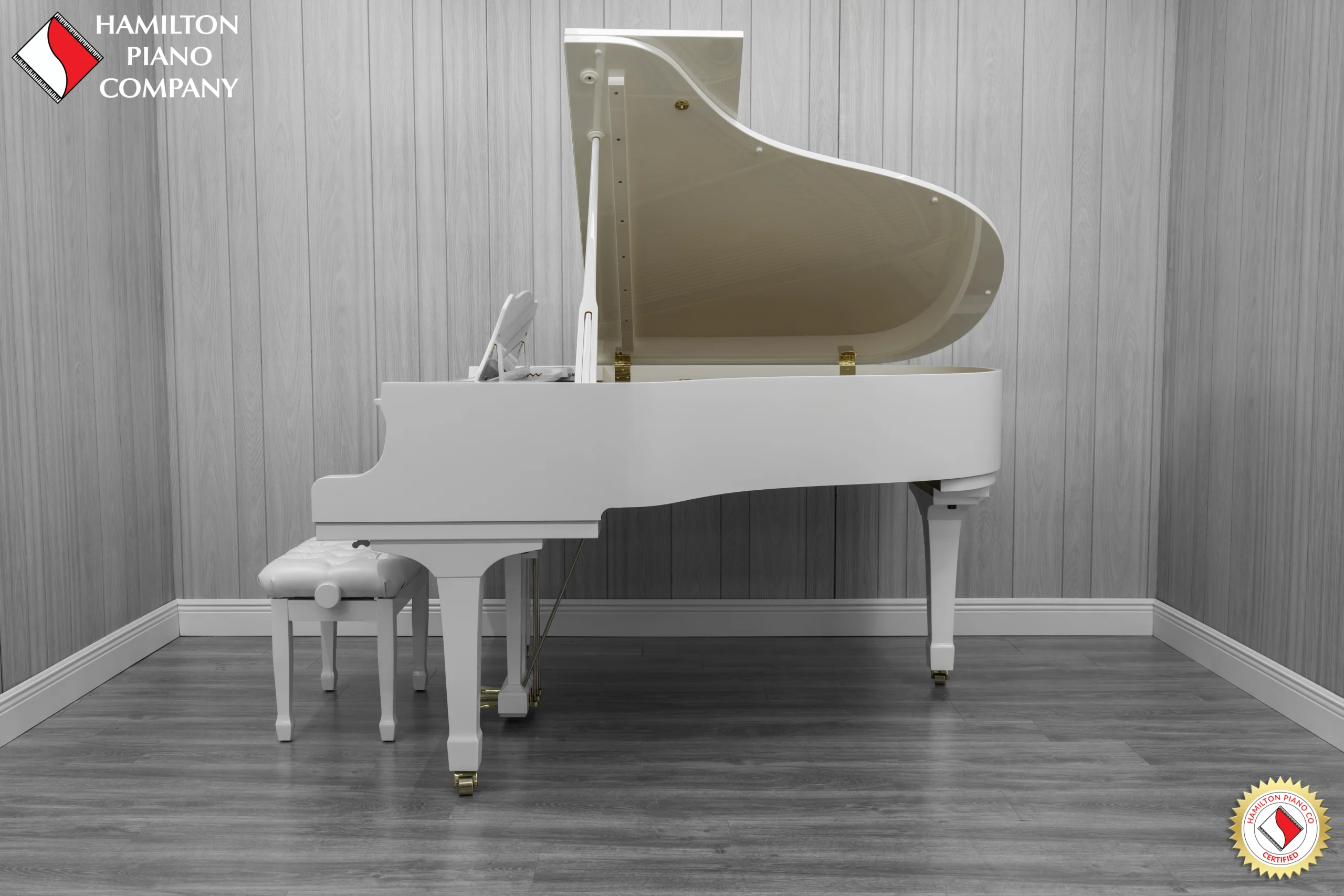 A 1980 Yamaha G3 Grand Piano in a high polish white finish with bench.