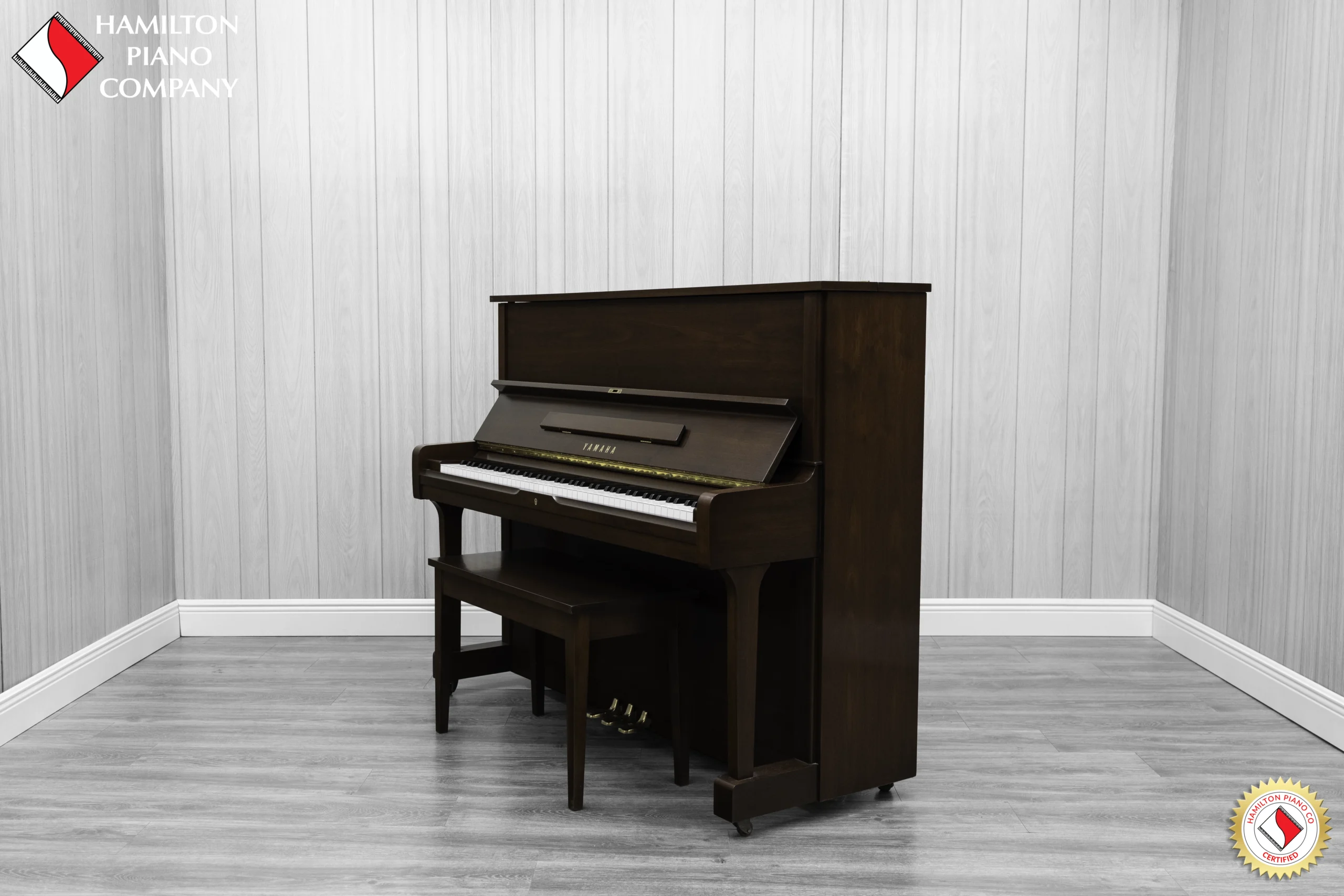 A Yamaha U1AR Vertical Piano in a satin walnut finish.