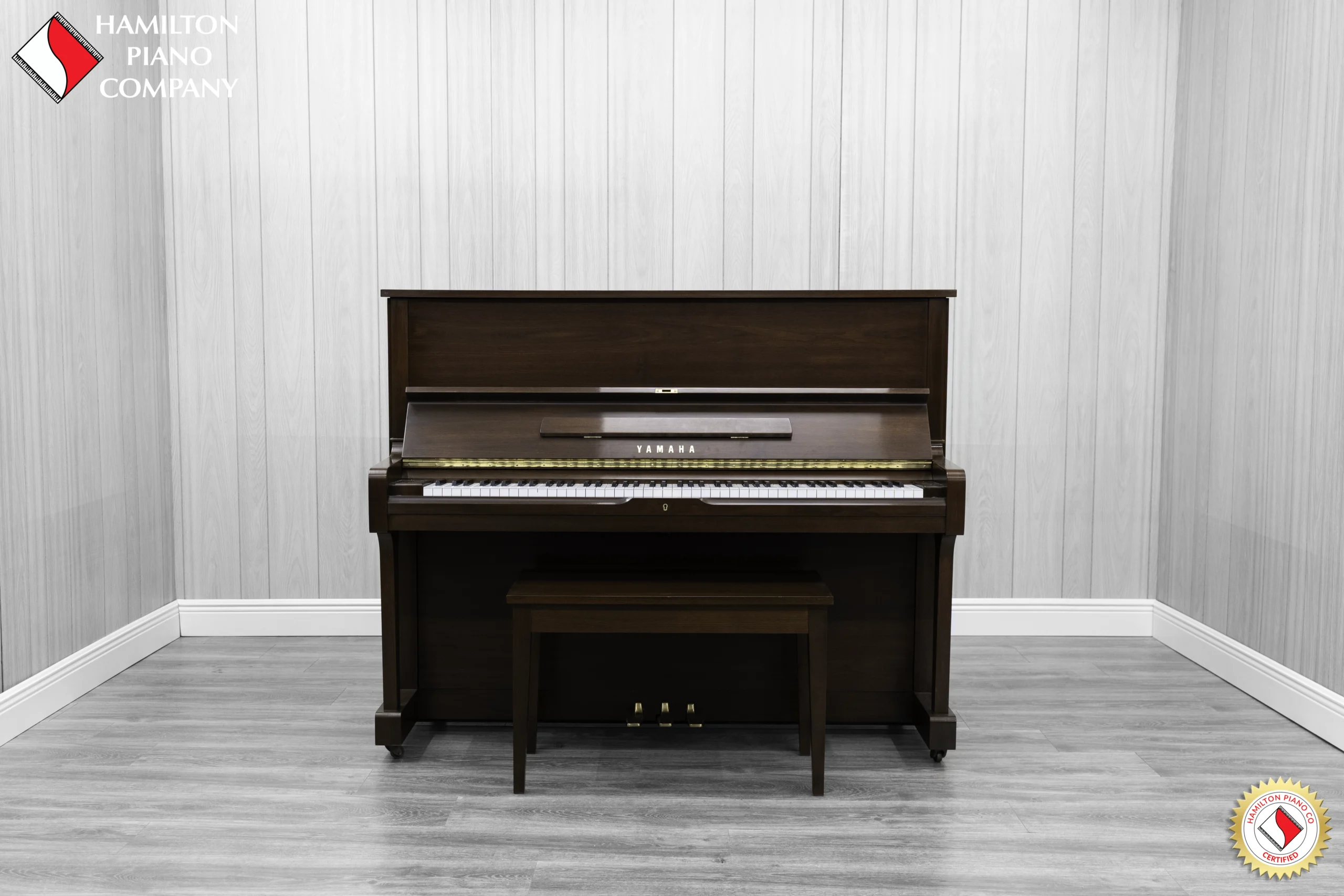 A Yamaha U1AR Vertical Piano in a satin walnut finish.