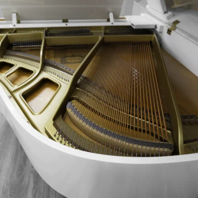 A Yamaha GH1 baby grand piano in a high polish white finish