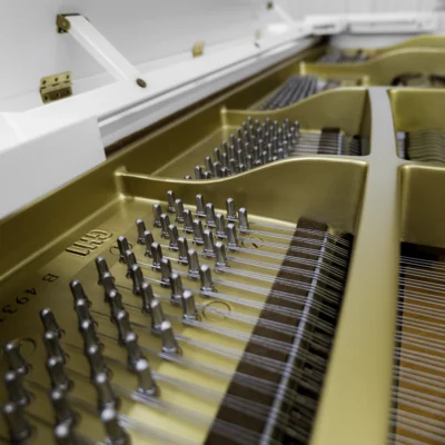 A Yamaha GH1 baby grand piano in a high polish white finish