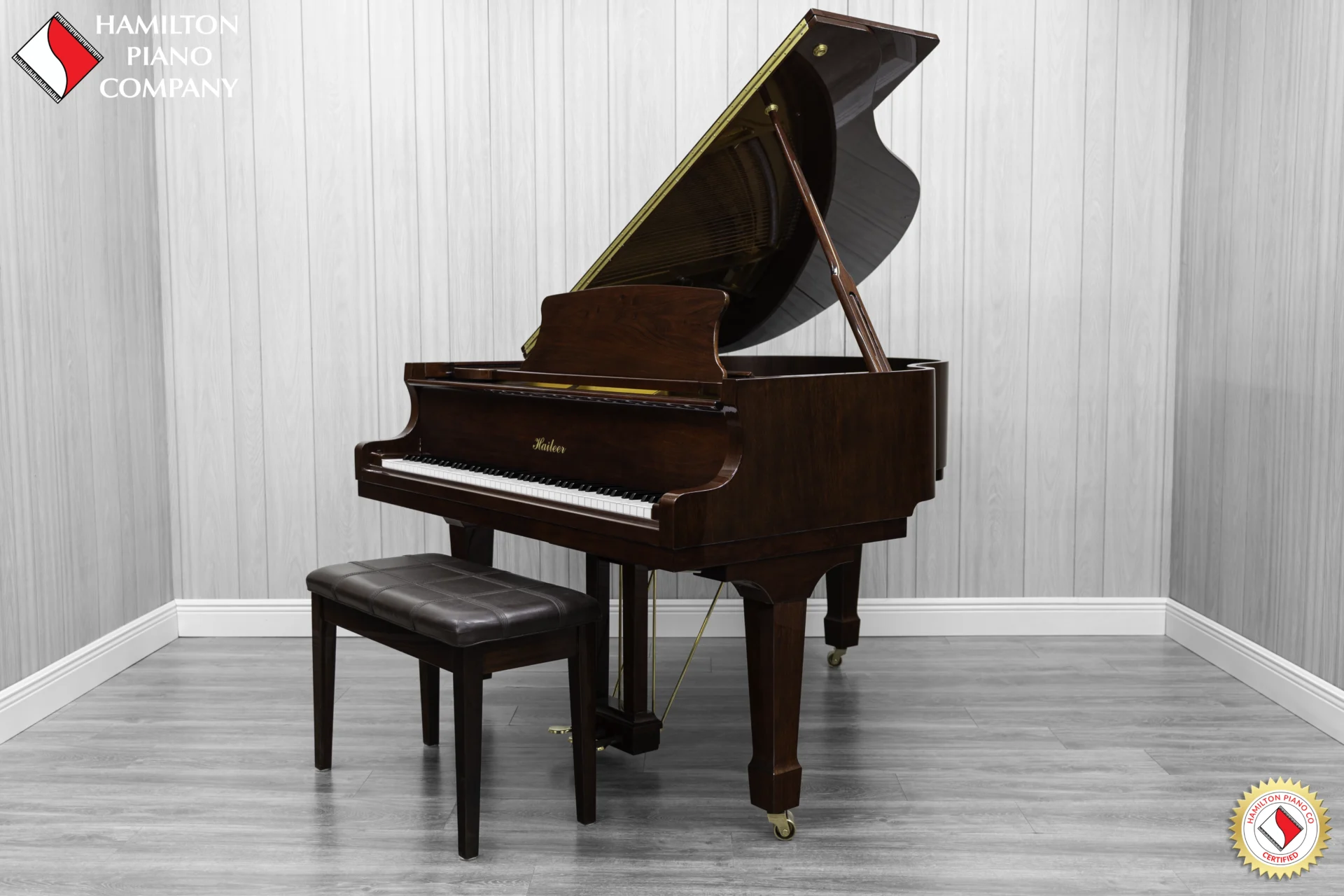 Haileer baby grand piano in high polish mahogany.
