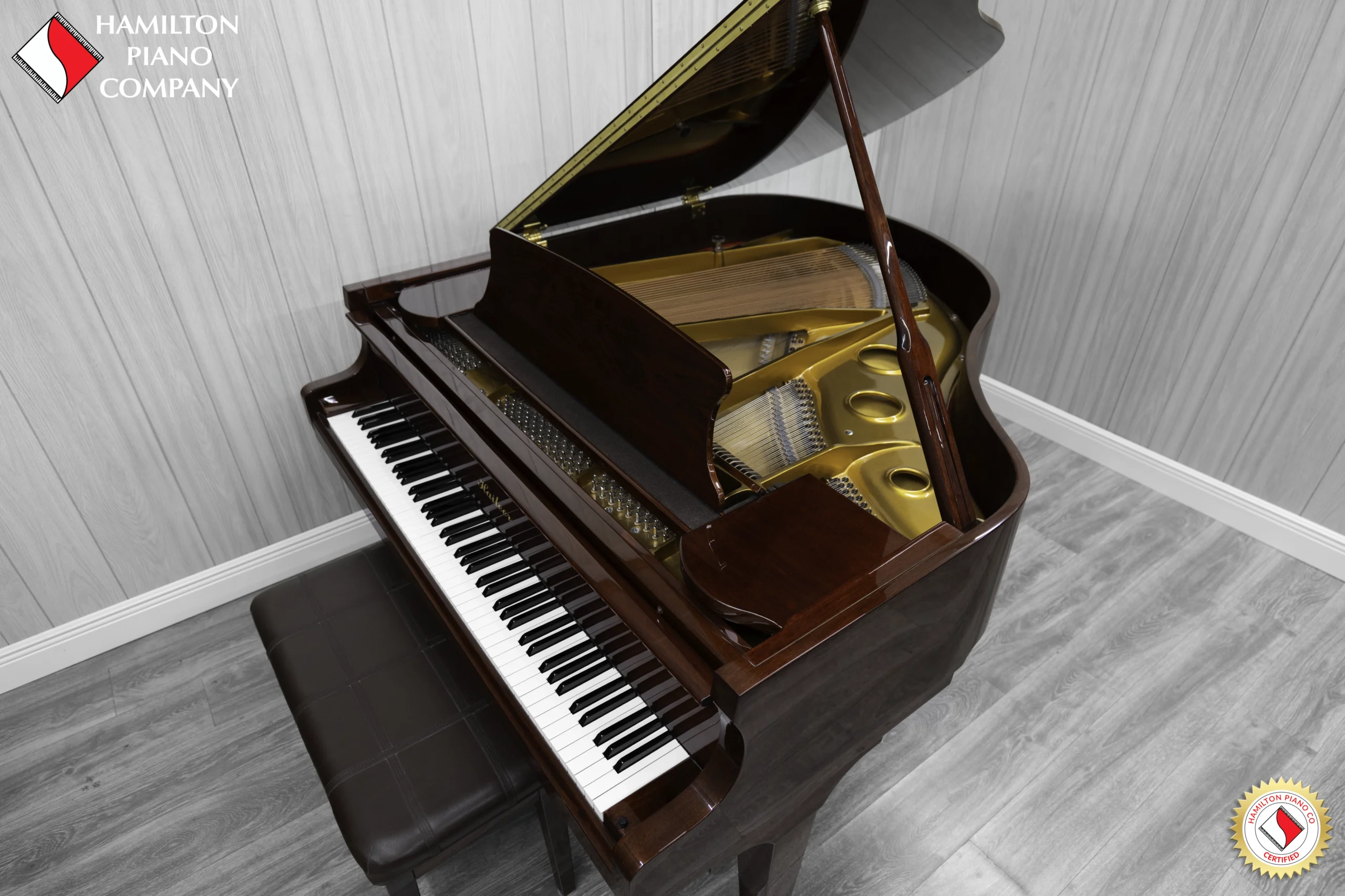 Haileer baby grand piano in high polish mahogany.