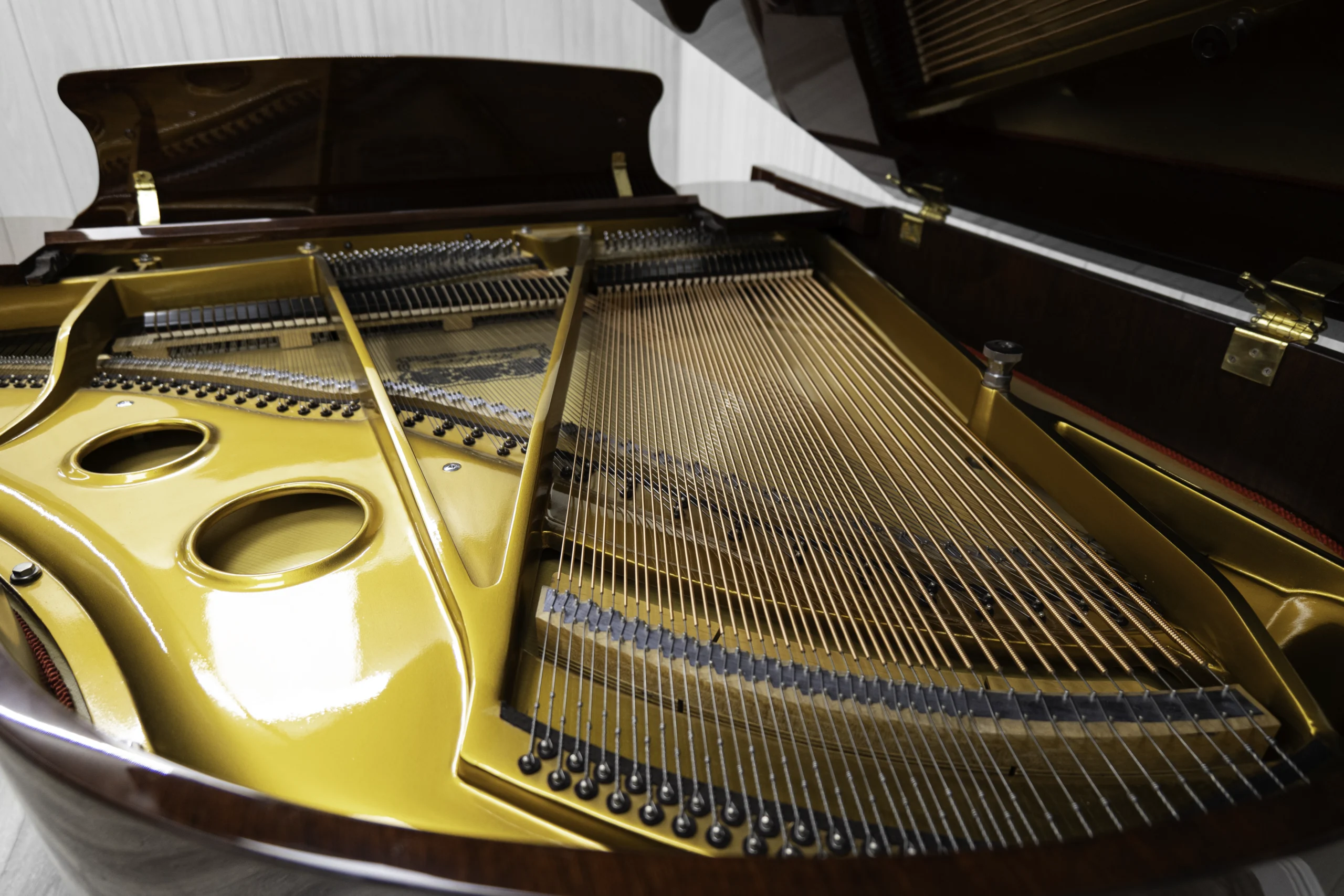 Haileer baby grand piano in high polish mahogany.