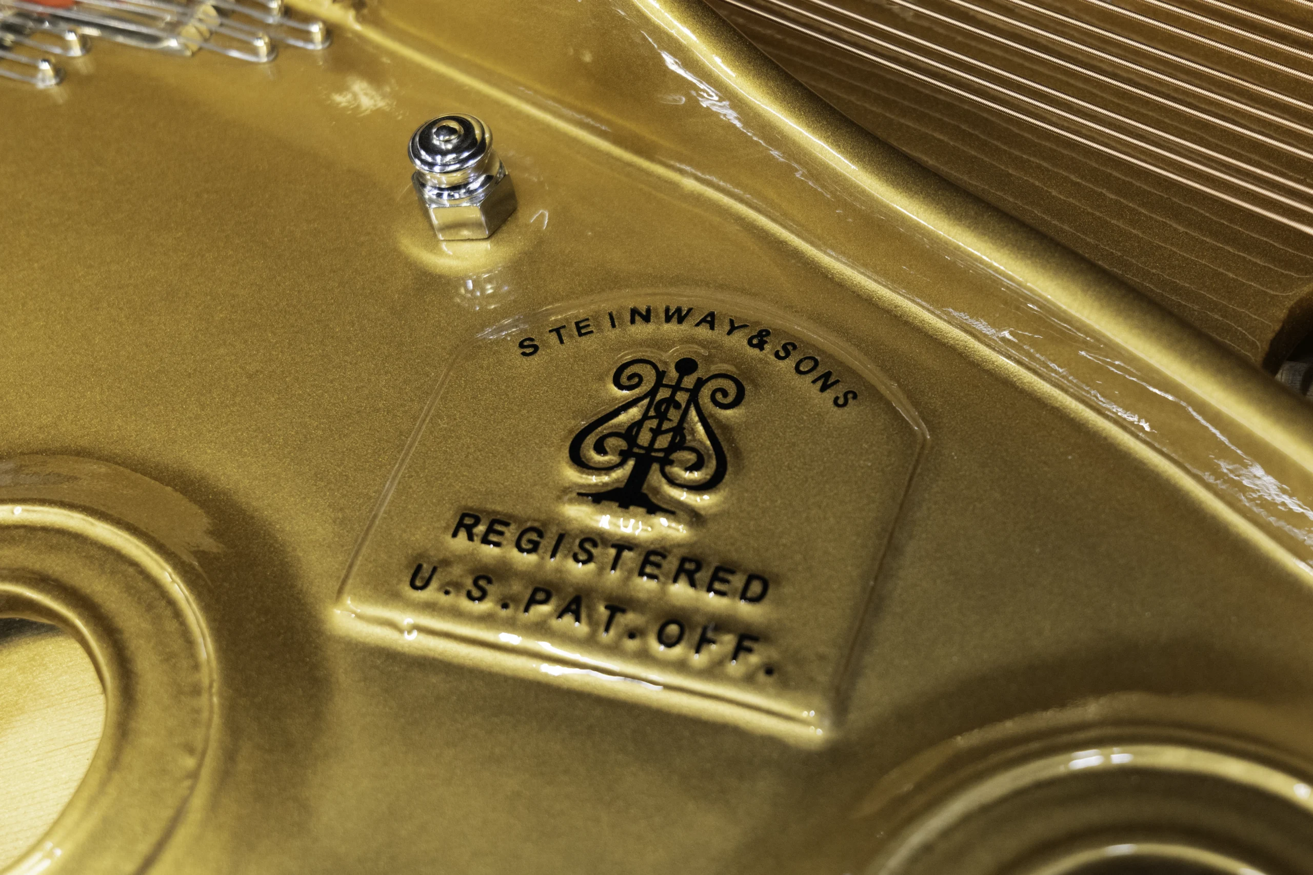 a close up on the Steinway logo on the harp of a Steinway D concert grand piano