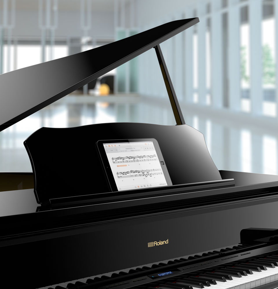 Roland GP609 digital grand piano with tablet on music desk